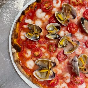 pizza with green leaves and red sauce