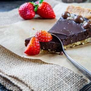 strawberry on brown cake on white textile