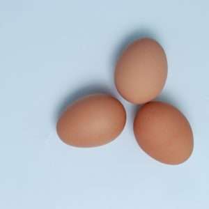 three eggs on a light blue background