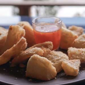 a plate of fried food with dipping sauce