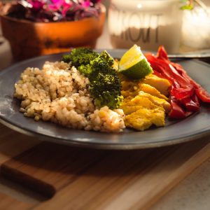 cooked rice with broccoli and carrots on plate