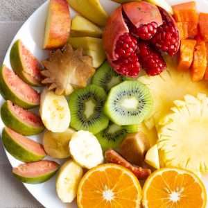a white plate topped with cut up fruit