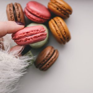 person holding french macarons