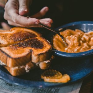 plate of toasted bread and bowl of pork and beans