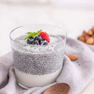 a glass of milk with berries on top