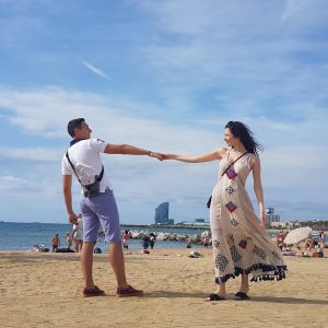 man and woman holding hands on beach