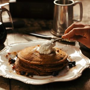 pancake with butter on white ceramic plate