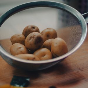 brown round fruits on white ceramic bowl