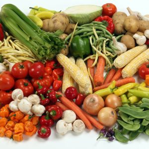 a pile of different types of vegetables on a white surface