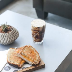 bread on white ceramic plate beside clear drinking glass