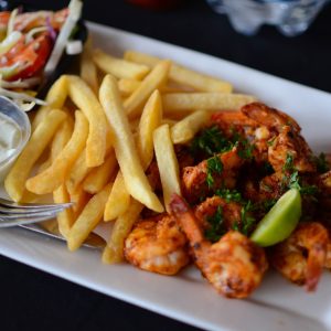 food photography of cooked shrimp and French fries