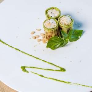 green and white sliced vegetables on white ceramic plate