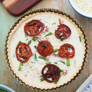 baked pastry surrounded by plates, bowls, and board