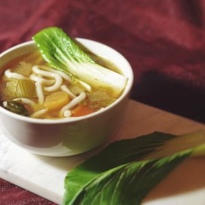 a white bowl filled with soup and vegetables