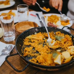 a pan filled with food sitting on top of a wooden table