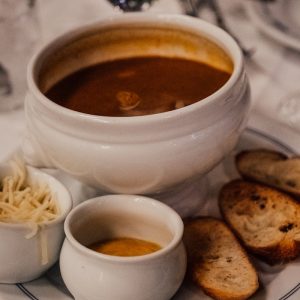 a white plate topped with soup and bread