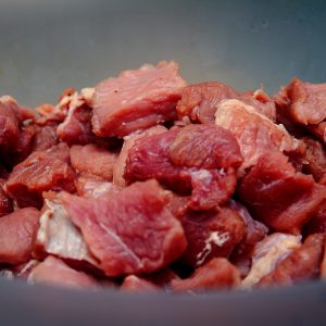 raw meat on blue ceramic bowl