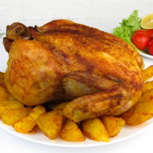 a roasted turkey and potatoes on a white plate