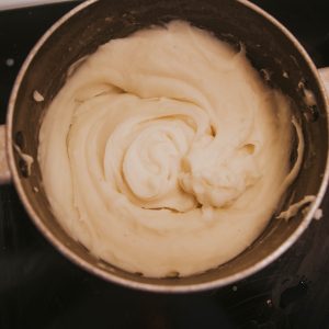 a pot of cream sitting on top of a stove