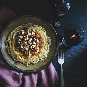 cooked pasta dish on round brown ceramic plate