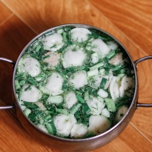 stainless steel cooking pot with white and green soup