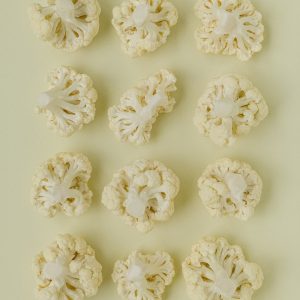 a bunch of cauliflower on a white surface