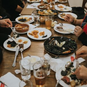 a group of people sitting around a table eating food