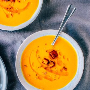 three bowls of soup with a smiley face drawn on the side