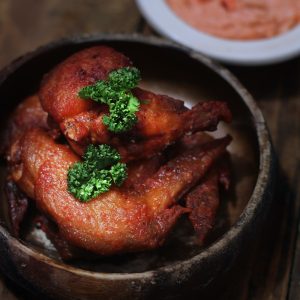fried chicken in brown wooden bowl
