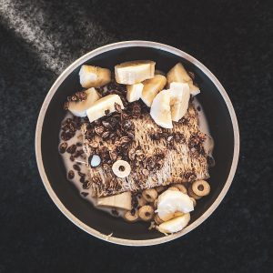 sliced banana in black and white ceramic bowl