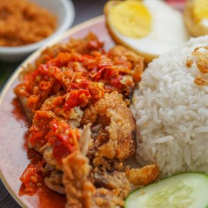 rice and fried meat with egg in plate