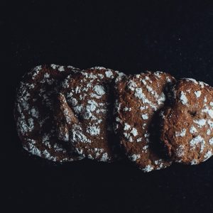 a close up of three cookies on a black surface