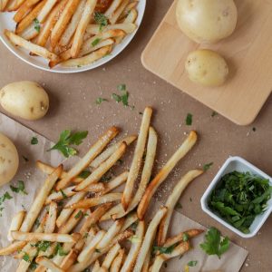 potato fries and sliced of vegetables on white ceramic plate