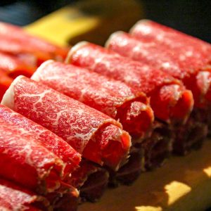 a close up of a bunch of meat on a cutting board