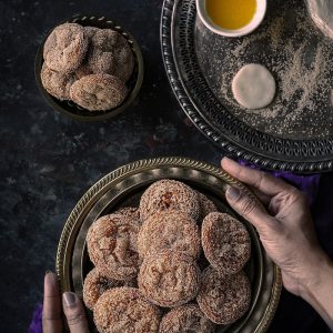 person holding brown round cookies