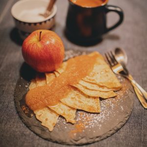 red apple fruit beside stainless steel fork and knife