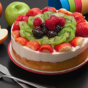 round cake with assorted fruits on top