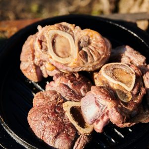 a close up of a grill with meat on it