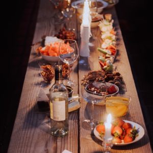 a long wooden table with plates of food on it
