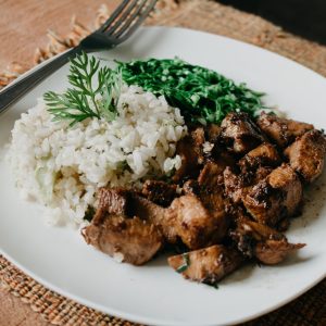 cooked meat and rice on plate
