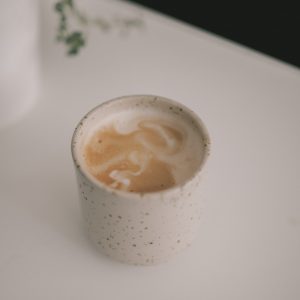 white ceramic cup with brown liquid