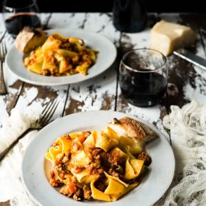 pasta on white plate near glass