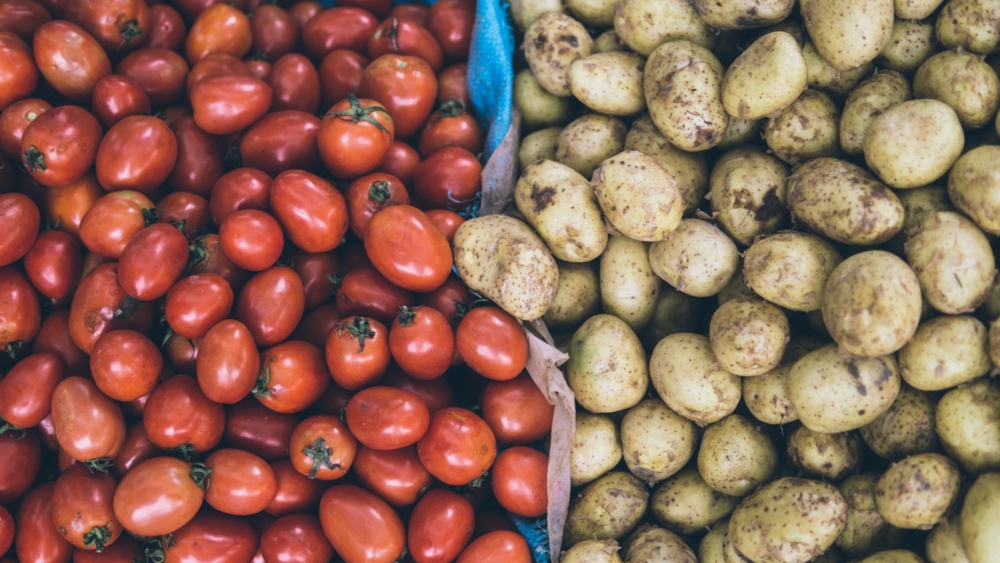 photography of orange tomatoes and brown potatoes