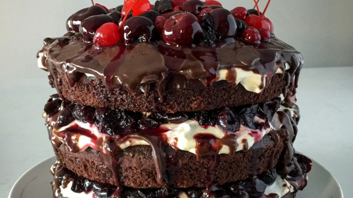 chocolate cake with strawberry on white ceramic plate