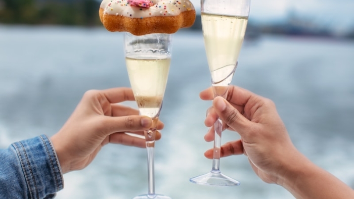 A couple of people holding wine glasses filled with food